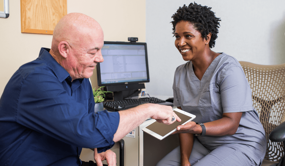 Man using tablet with healthcare provider