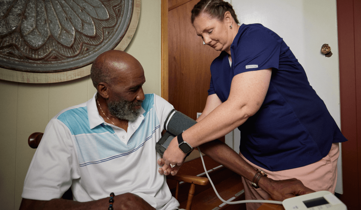 A healthcare professional taking blood pressure measurements for a patient