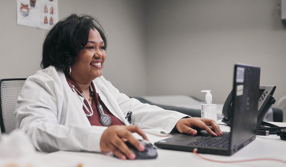 A healthcare provider on her laptop