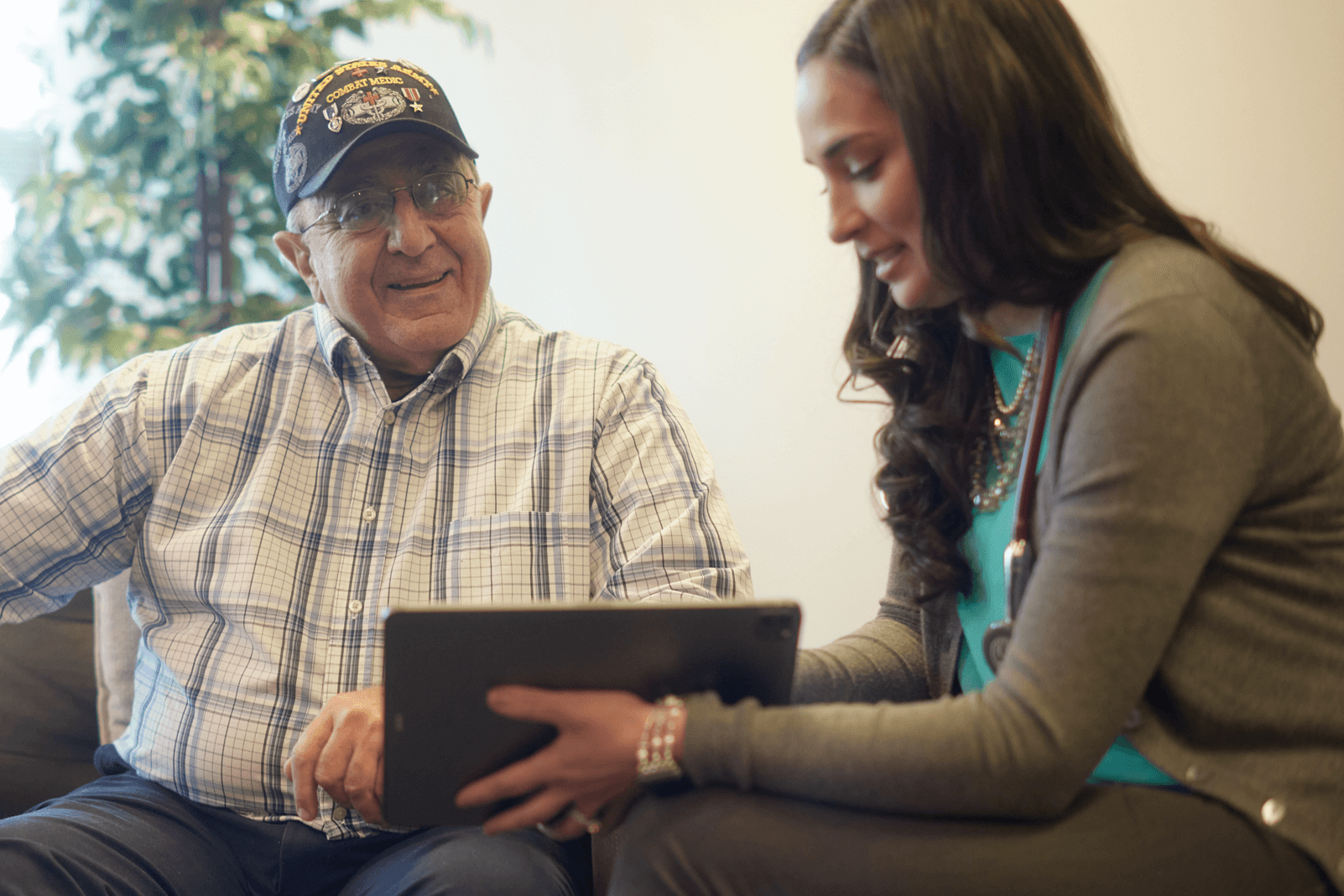 Healthcare provider showing Veteran something on a tablet